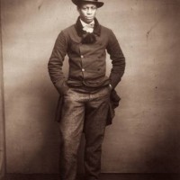 Young man wearing a formal suit and top hat.
