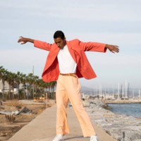 young man with arms outstretched dancing while standing against sky - fashion stock pictures, royalty-free photos & images