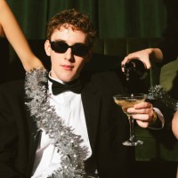 young man with ladies celebrating new year's eve - fashion stock pictures, royalty-free photos & images