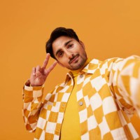 young man with vitiligo gesturing peace sign - fashion stock pictures, royalty-free photos & images