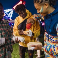 young men eating festival hot dogs - junk food stock pictures, royalty-free photos & images