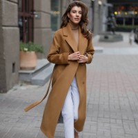 young model with long hair in light brown coat goes towards the camera. - fashion stock pictures, royalty-free photos & images