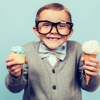 young nerd boy holds ice cream and cupcakes - junk food stock pictures, royalty-free photos & images