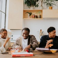 young people enjoy a fresh, delicious pizza, directly from a cardboard pizza box. - junk food stock pictures, royalty-free photos & images