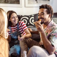 young people in casual clothes eating pizza, talking, and laughing - junk food stock pictures, royalty-free photos & images