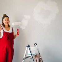young pregnant woman painting nursery and having fun - home decoration stock pictures, royalty-free photos & images
