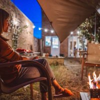 young pretty woman enjoying the campfire with friends in the garden party at home - garden decoration stock pictures, royalty-free photos & images