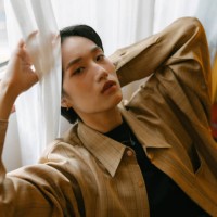 young stylish asian woman with short hair sitting and relaxing in western vintage style room or cafe indoors in daytime - fashion stock pictures, royalty-free photos & images