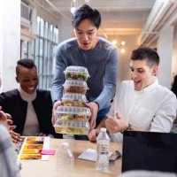 young team eating in the office at lunch break - junk food stock pictures, royalty-free photos & images