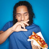 young urban man eating hotdog - junk food stock pictures, royalty-free photos & images