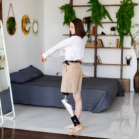 young woman amputee with prosthesis trying on new clothes at home - fashion stock pictures, royalty-free photos & images