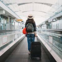 young woman at the airport with a suitcase - travel stock pictures, royalty-free photos & images