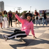 young woman breakdancing during street party with her friends outdoors - concert stock pictures, royalty-free photos & images