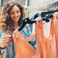 young woman browsing in the fashion store - fashion stock pictures, royalty-free photos & images