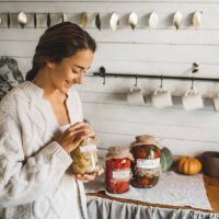 young woman cans and pickles vegetables. - food stock pictures, royalty-free photos & images