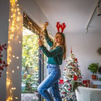 young woman decorating home for the upcoming holidays - home decoration stock pictures, royalty-free photos & images