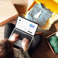young woman doing online shopping with laptop sitting on the floor at home - fashion stock pictures, royalty-free photos & images