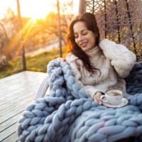 young woman drinking coffee at the beautiful terrace in the swing chair. - garden decoration photos et images de collection