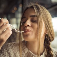 young woman eating dessert - food stock pictures, royalty-free photos & images