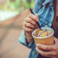 young woman eating healthy rolled ice-cream or yogurt with fruits or berries, cookies, candy and mint - junk food stock pictures, royalty-free photos & images