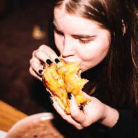 young woman eating homemade pizza - junk food stock pictures, royalty-free photos & images