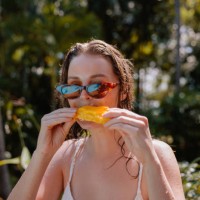 young woman eating mango on vacation - food stock pictures, royalty-free photos & images