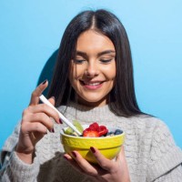 young woman eating muesli breakfast - food stock pictures, royalty-free photos & images