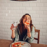 young woman eating pizza in restaurant - food stock pictures, royalty-free photos & images