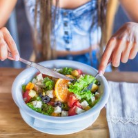 young woman eating salad for lunch - food stock pictures, royalty-free photos & images