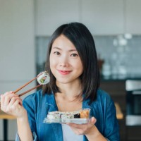 young woman eating takeaway sushi rolls - junk food stock pictures, royalty-free photos & images