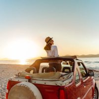 young woman enjoying the seaside road trip - travel stockfoto's en -beelden