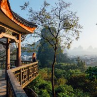 young woman enjoys view over yangshuo, karst mountains - travel stock pictures, royalty-free photos & images