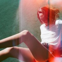 young woman falling backward and smiling in sports clothing - fashion stock pictures, royalty-free photos & images
