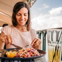 young woman having lunch by the sea - food stock pictures, royalty-free photos & images