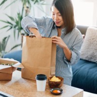 young woman having takeaway meal at home - food stock pictures, royalty-free photos & images