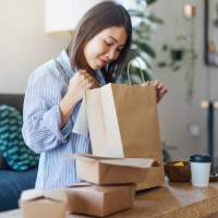 young woman having takeaway meal at home - junk food stock pictures, royalty-free photos & images