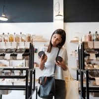 young woman holding jars in zero waste store - food stock pictures, royalty-free photos & images