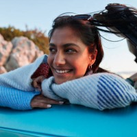 young woman leaning on car during vacation - home decoration stockfoto's en -beelden