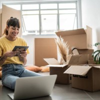 young woman looking at a photo frame at new house - home decoration stock pictures, royalty-free photos & images