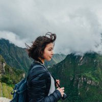 young woman looking at view from machu picchu in peru - travel stockfoto's en -beelden