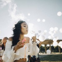 young woman making smoke bubbles while enjoying with friends at music concert - concert stock pictures, royalty-free photos & images