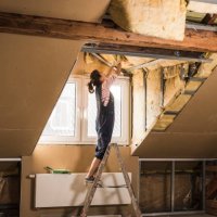 young woman mounting insulation in her new home - home decoration stock pictures, royalty-free photos & images