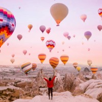young woman on a background of flying balloons at sunrise in cappadocia - travel stock pictures, royalty-free photos & images