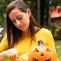 young woman painting and carving halloween pumpkins - garden decoration stock pictures, royalty-free photos & images