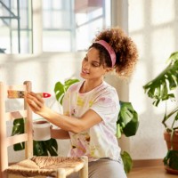young woman painting chair at home - home decoration stock pictures, royalty-free photos & images