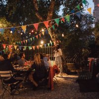 young woman photographing friends during dinner party in backyard - garden decoration stock pictures, royalty-free photos & images
