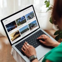 young woman planning a sustainable travel with laptop - travel stock pictures, royalty-free photos & images