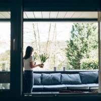 young woman planting freesias on her terasse in spring. - garden decoration stockfoto's en -beelden