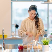 young woman preparing breakfast in kitchen - food stock pictures, royalty-free photos & images