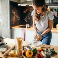 young woman preparing pizza - food stock pictures, royalty-free photos & images